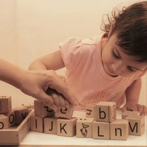 Playing baby with wooden English alphabet toys
