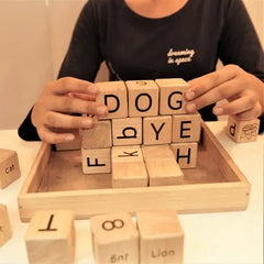 Playing Girl with Wooden English alphabet toys